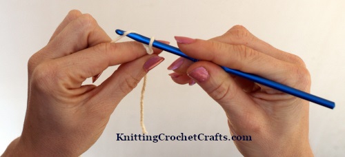 Learn How to Crochet a Chain Stitch. Step 2: Wrap the Yarn Around Your Crochet Hook.