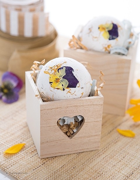 If you're growing violets or similar delicately beautiful flowers in your garden, here's a creative use for some of them: They can become the focal point of these pretty floral bath bombs from Make & Give Home Apothecary by Stephanie Rose, published by Leisure Arts.