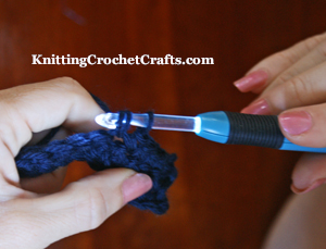 Crocheting  dark-colored yarn with a Crochet Lites crochet hook -- As you can see, the light helps you to see your stitches better.