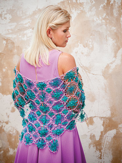 The Petal Shawl, a hybrid craft project featuring hand-loomed flowers and crochet. The pattern for this shawl is included in Flower Loom Crochet by Beth Ham & Kristen Magnus, Published by Annie's Crochet.