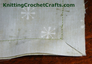 Use your scissors to clip both of the lower corners on the diagonal, making sure to cut through both layers of fabric.