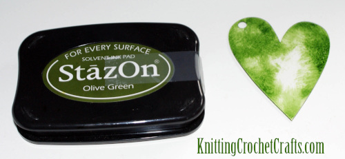 Stazon Ink Pad in the Olive Green Colorway Plus a Clear Acrylic Heart Shape by Clear Scraps That Has Been Inked With StazOn
