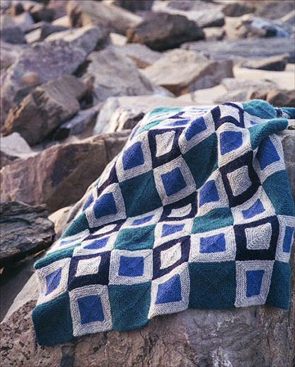 Color Blocks Blanket Knitting Pattern: You can knit this sophisticated blanket using easy garter stitches and four colors of worsted weight wool yarn. This pattern is included in Martin Storey's Afghan Knits. There's also a similar pillow pattern included in the book. 