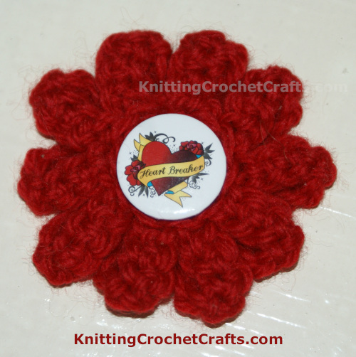 Abstract Crocheted Flower Motif Embellished With a Heart Pin