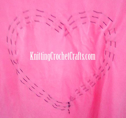 I used basting stitches to create a heart design in preparation for tie dyeing a heart shape.