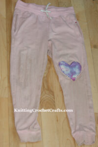 Child's Pants Mended With a Handmade, Tie-Dyed, Heart-Shaped Patch