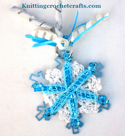 Snowflake-shaped mini scrapbook album with beaded crochet snowflake on the cover