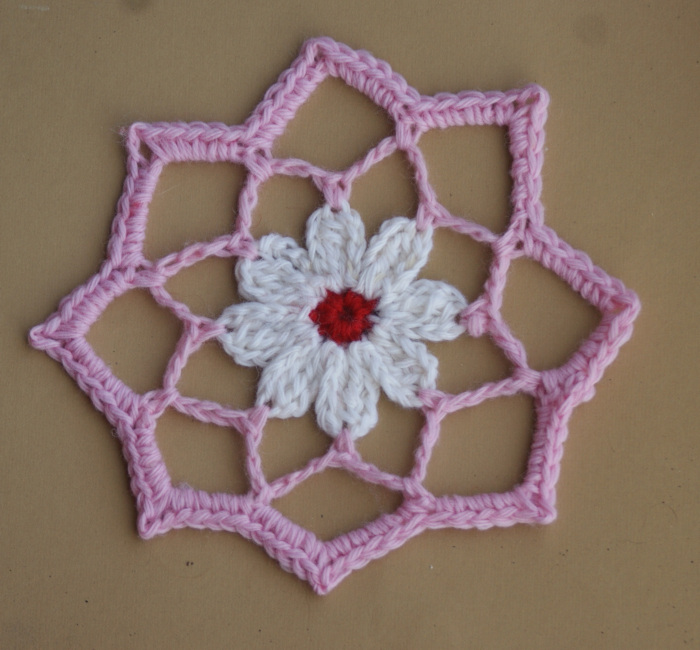 How would you classify this design? Is it a crochet flower? Is it an octagon? Is it an 8-pointed star? Is it a small doily? I think it could be perceived as any of the above. The pattern is from the book Crochet Kaleidoscope by Sandra Eng, published by Interweave. This is a Christmas-friendly colorway of the design which is not included in the book. Crocheted and photographed by Amy Solovay.